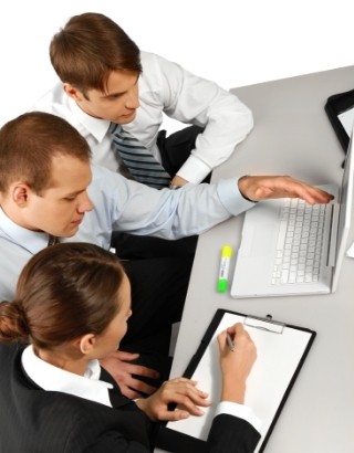 three people at work station