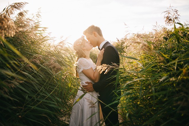 photo of couple kissing in a field