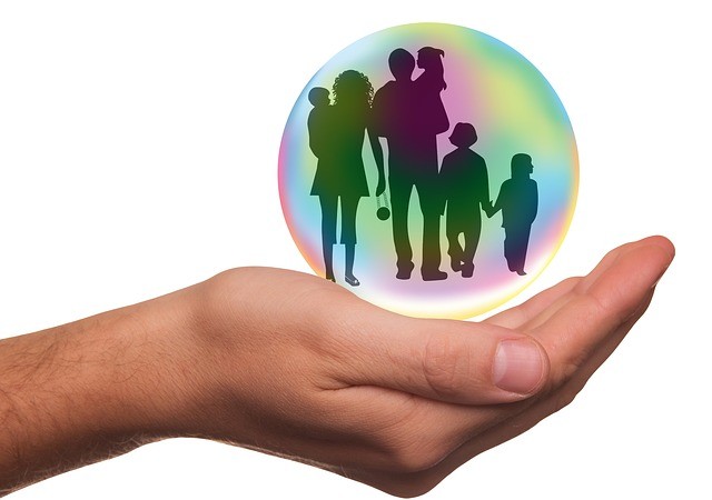 graphic of family in a globe sitting in a hand