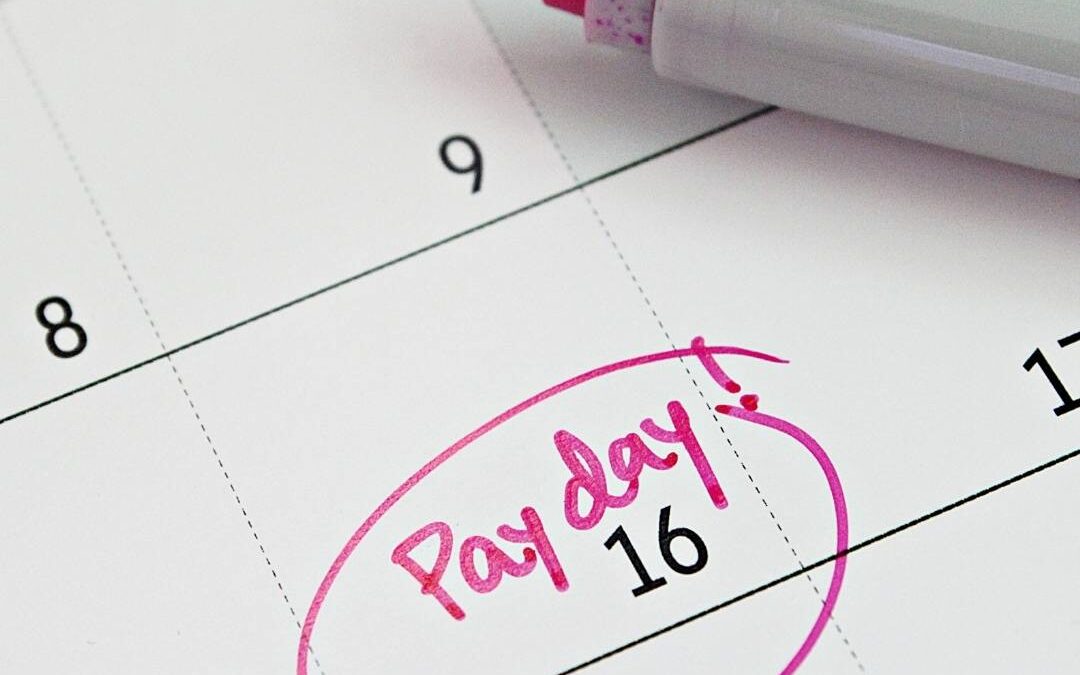 picture of a calendar with the word "Paycheck" circled on it.