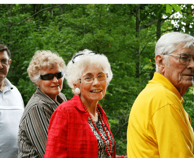 Photo of two older couples in an outdoor setting